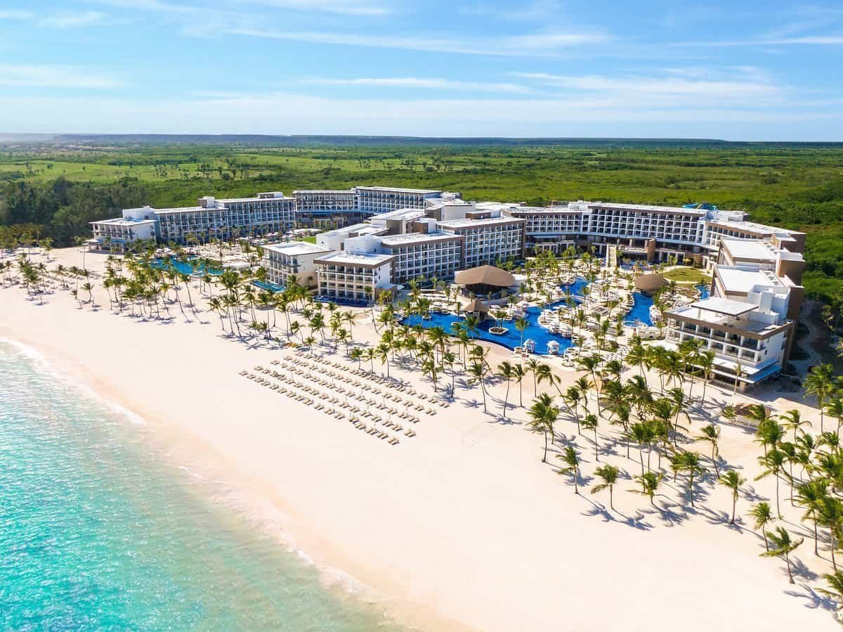 B\u00e1varo Beach in Punta Cana boasts powdery white sands and crystal-clear turquoise waters, perfect for relaxation and water sports. Lined with palm trees and luxury resorts, it features beach bars and restaurants, offering a lively atmosphere and stunning sunsets. A popular spot for both tranquility and adventure, it captures the essence of a tropical paradise.